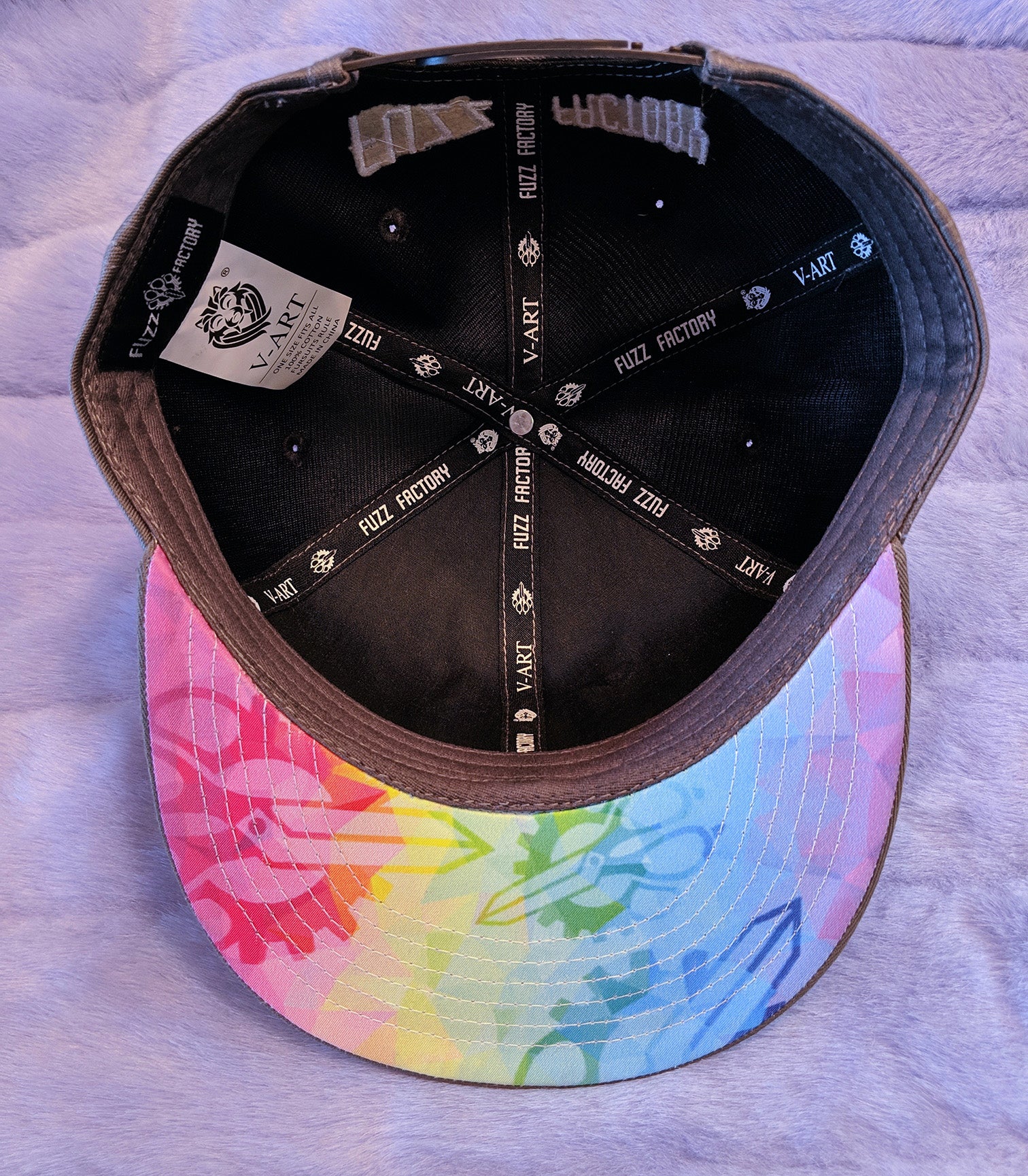 Colorful geometric pattern under the brim of the cap with a black interior on a fur background