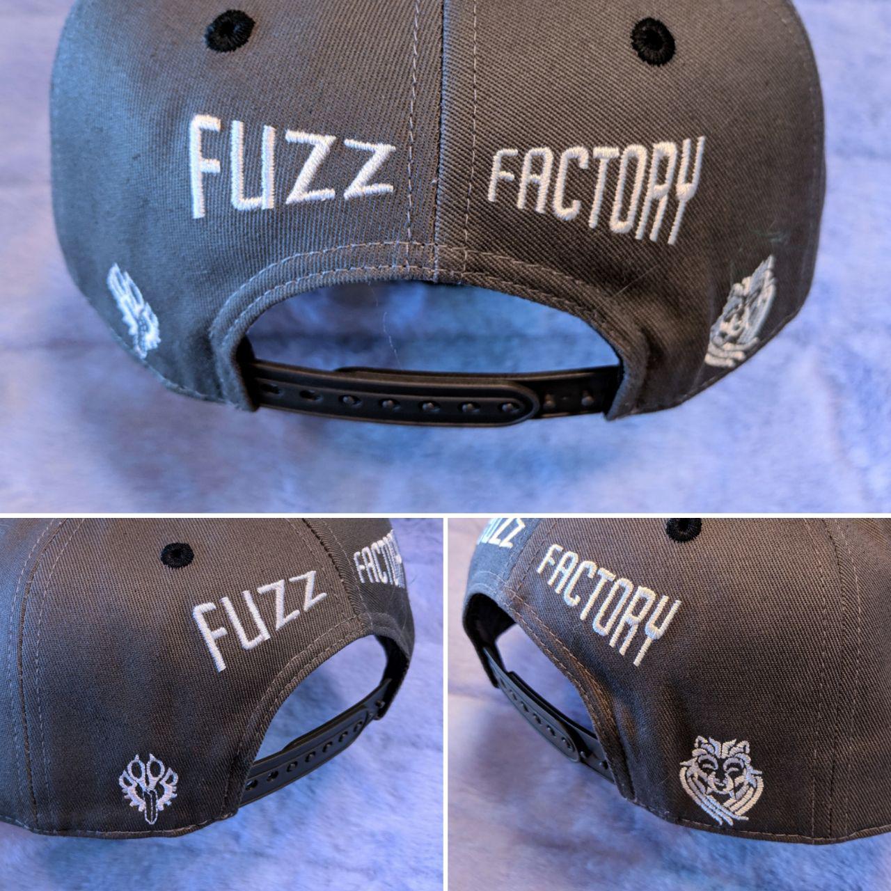 Gray cap with 'Fuzz Factory' branding on a fur background