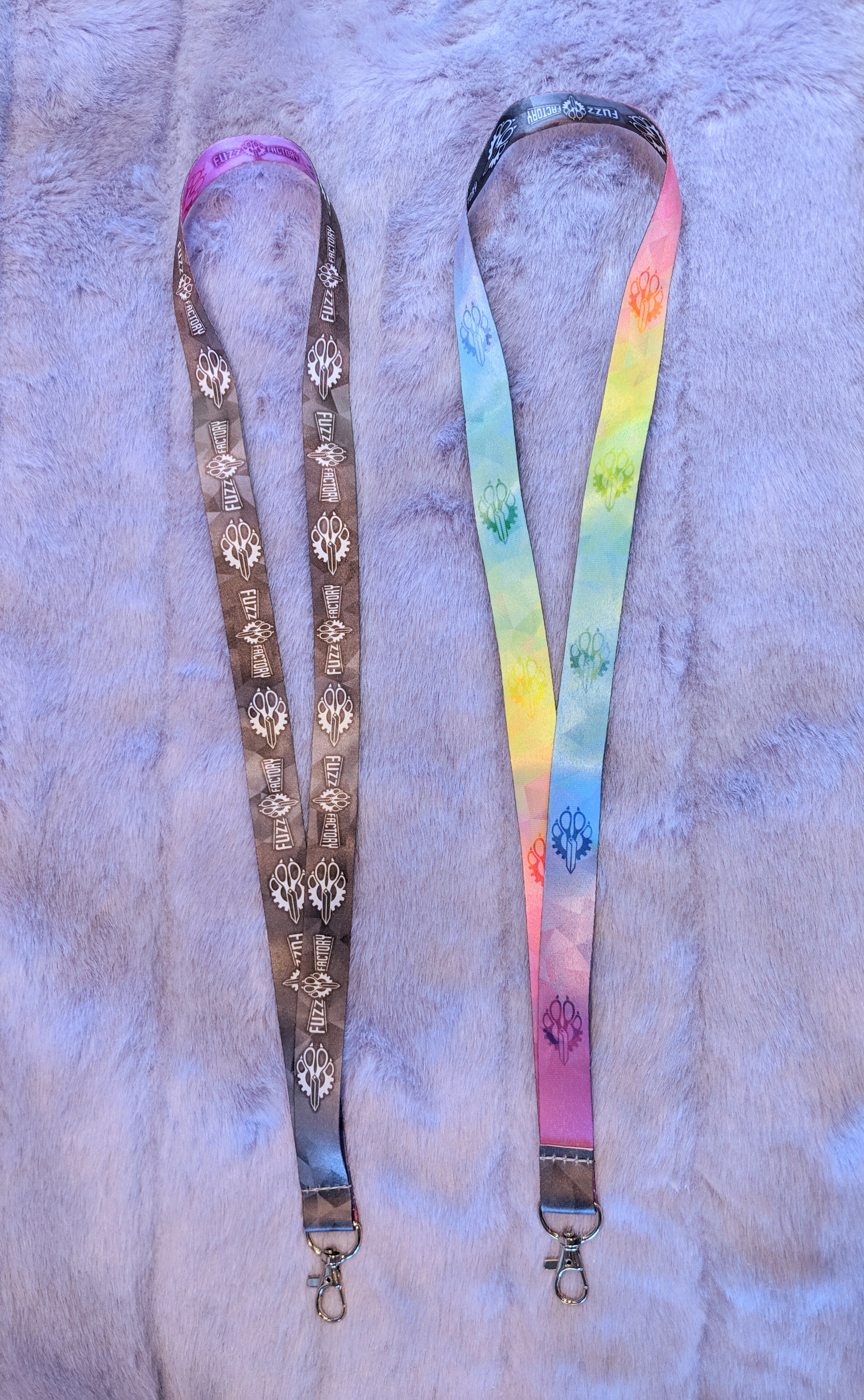 Two lanyards with decorative patterns on a textured surface